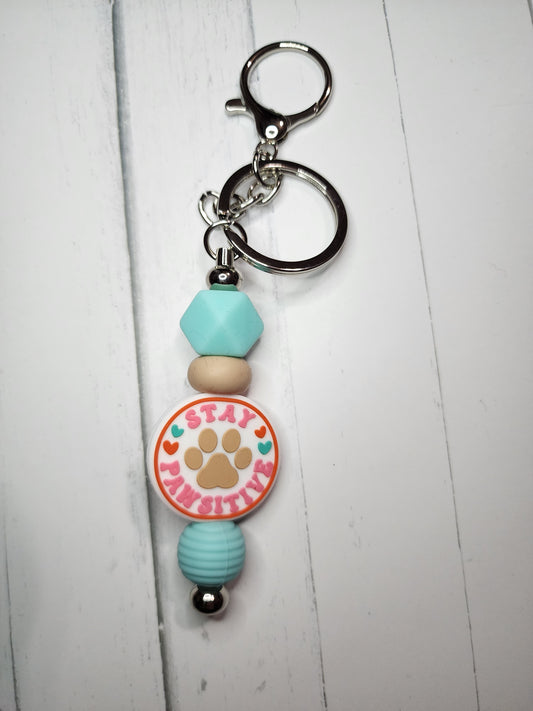 Stay pawsitive (aqua hexagon) keychain